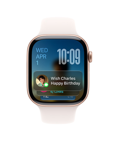 Apple Watch Series 11 w kolorze różowego złota z paskiem w kolorze łagodnego różu. W lewym górnym rogu tarczy widać datę, w prawym górnym rogu godzinę, a u dołu widżet Wiadomości