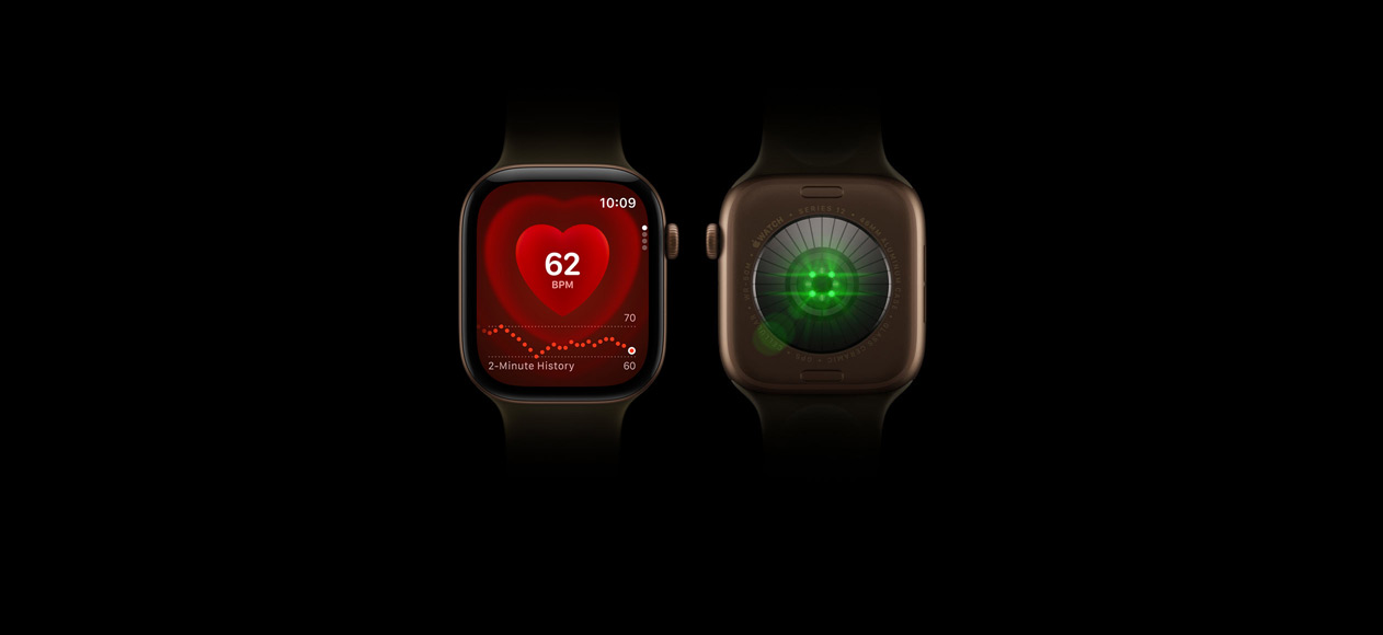 Two Apple Watch Series 12 devices, aluminium case, dark bronze colour, olive Sport Band, one showing front of watch with Heart Rate app, one showing back of watch with Health Sensing System with glowing green LED lights