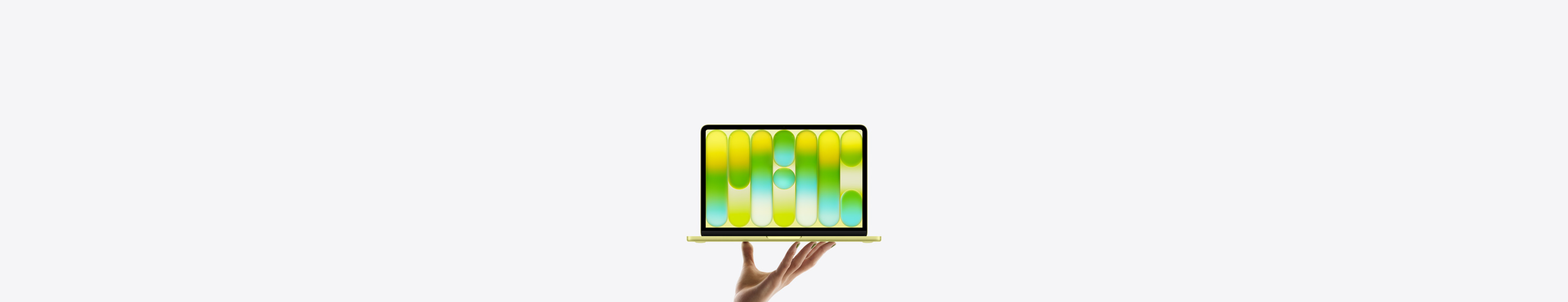 MacBook Neo in bright citrus colour, balanced on fingertips of open hand, screen displaying colourful abstract pattern